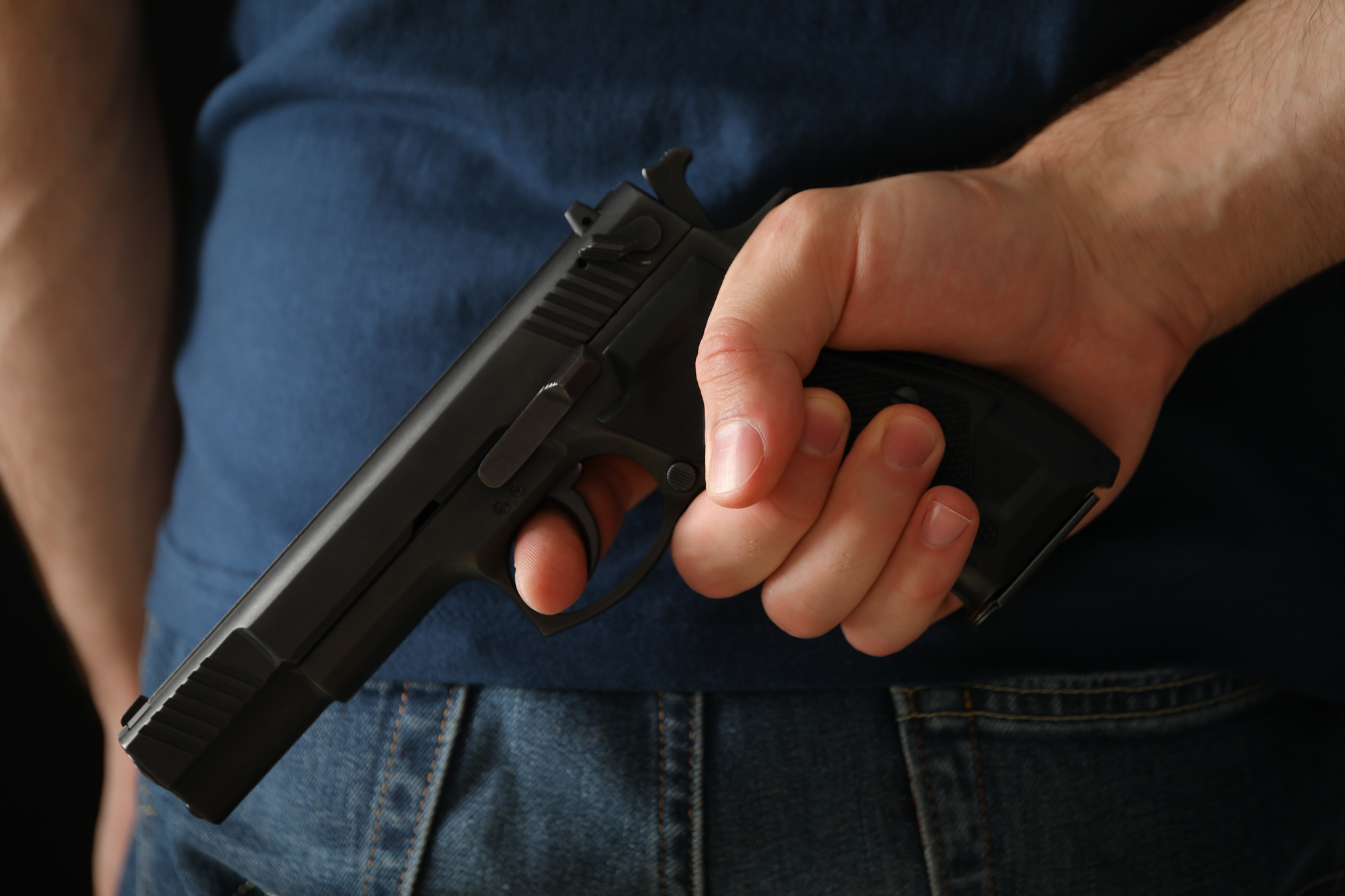 A Man Hold a Gun from behind. Self Defense Weapon